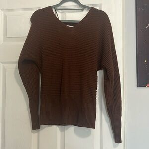 Sweater is super comfy feels like a crop top but very stylish the back is open